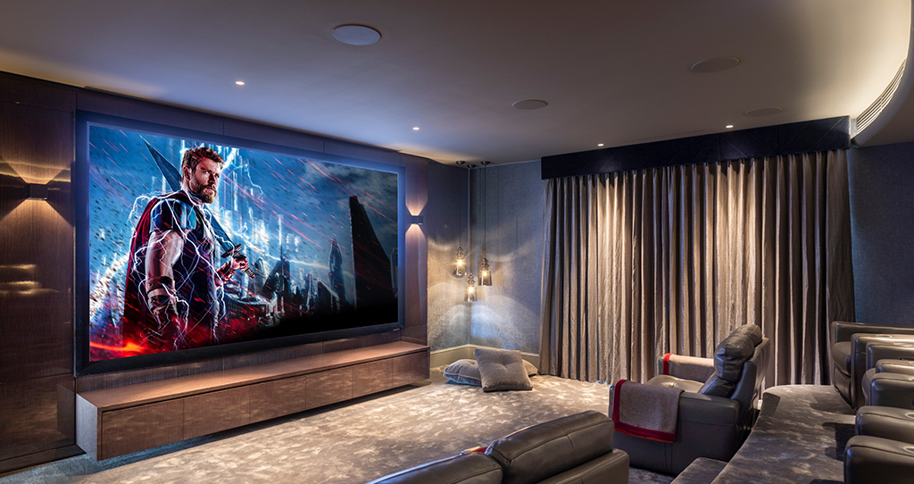 Custom home cinema room with large screen, seating and Dolby Atmos audio system