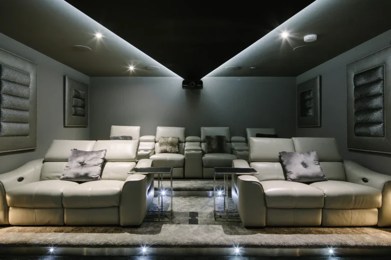 Bespoke cinema room with luxurious seating, projector and lighting design