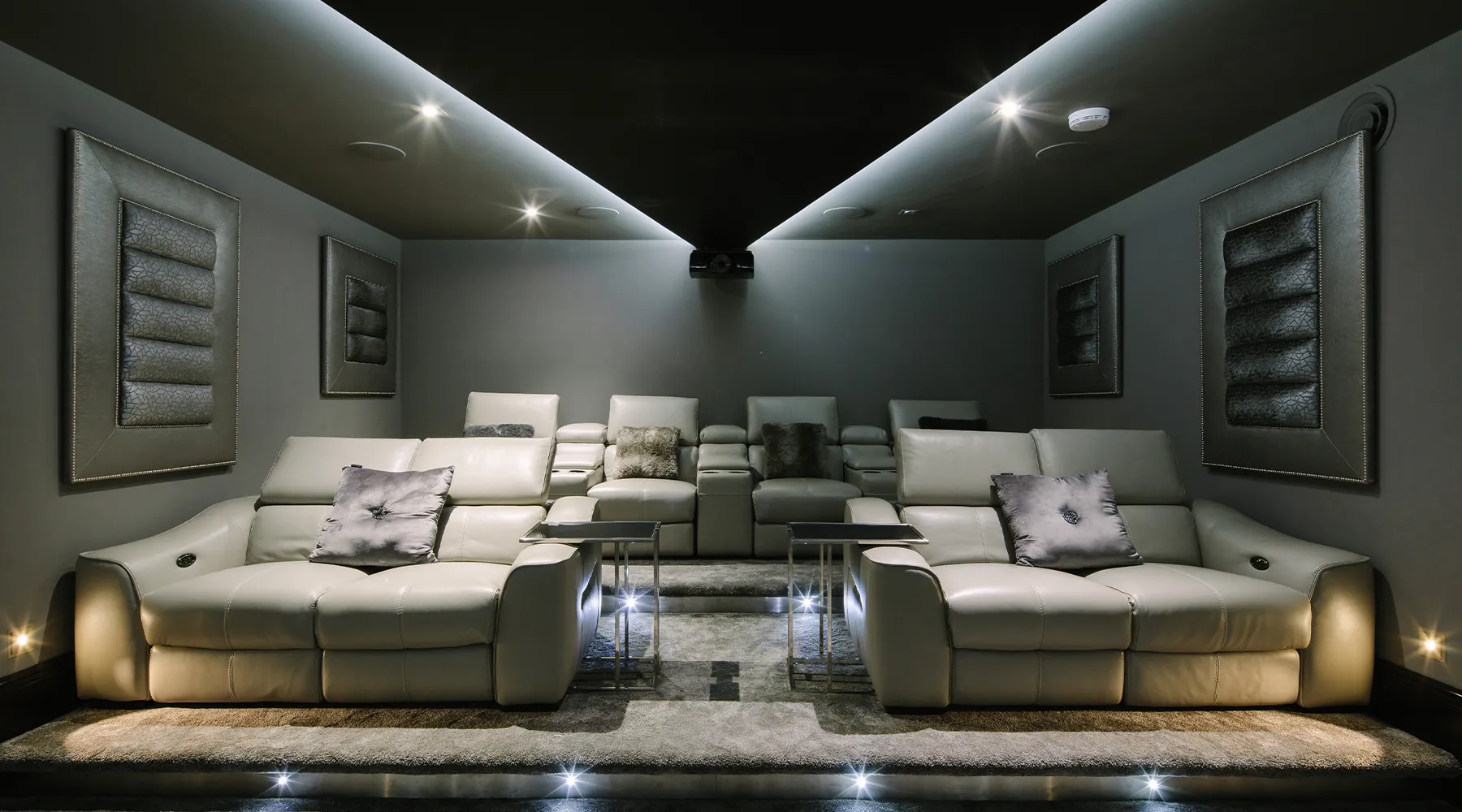 Bespoke cinema room with luxurious seating, projector and lighting design